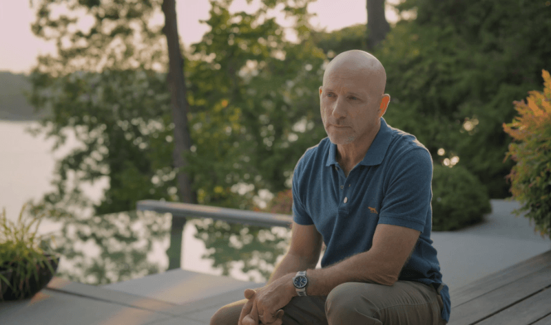 image of Chris Walker sitting on waterfront home deck