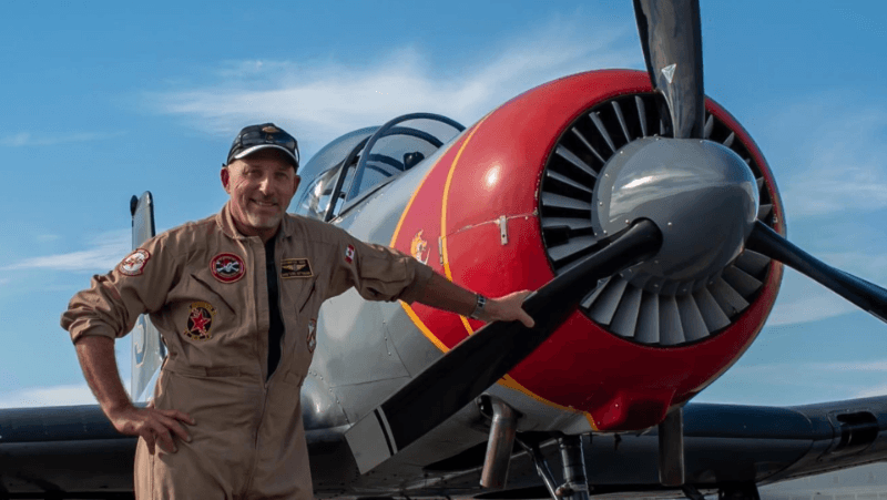 Chris Walker standing with his plane