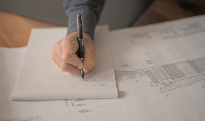 Chris Walker taking budget notes at his desk