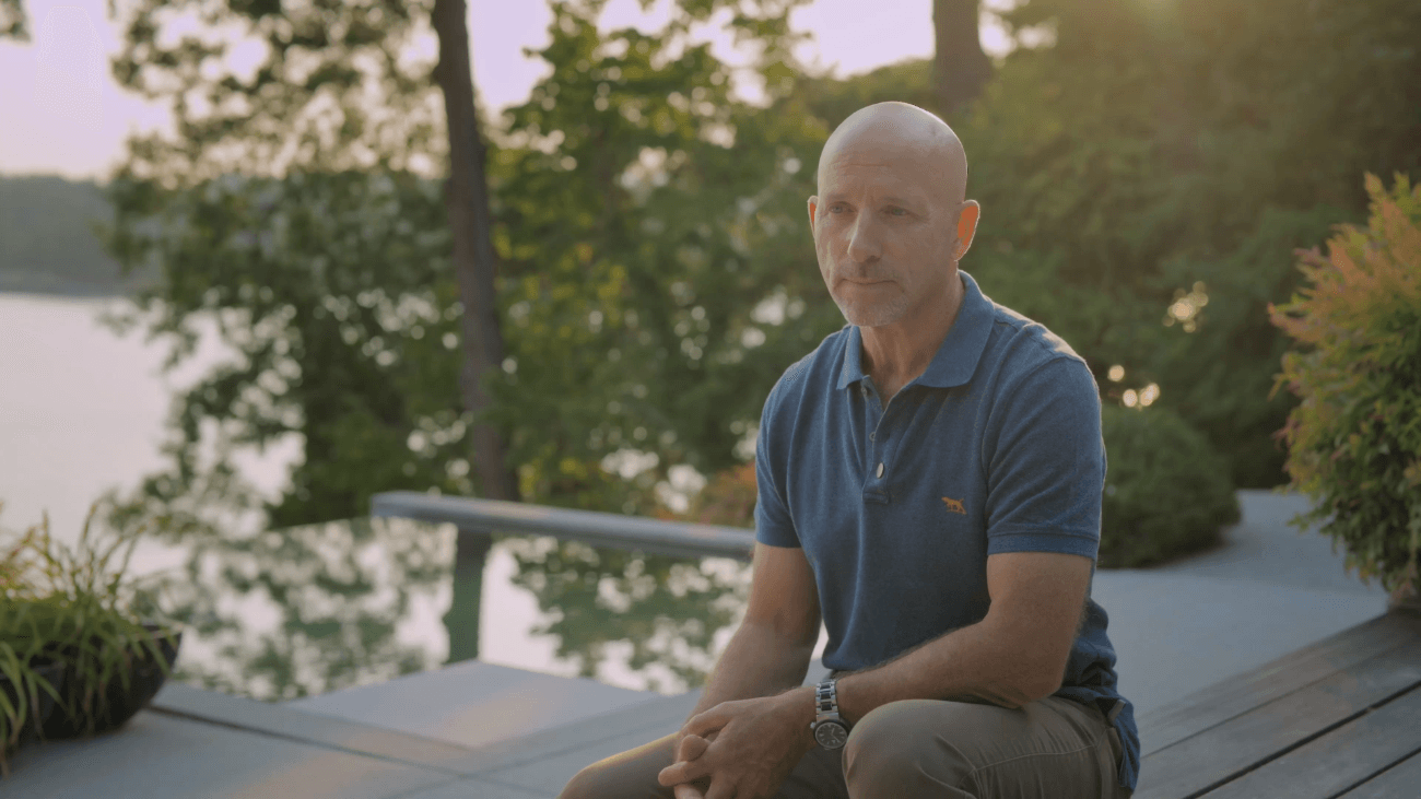 image of Chris Walker sitting on waterfront home deck